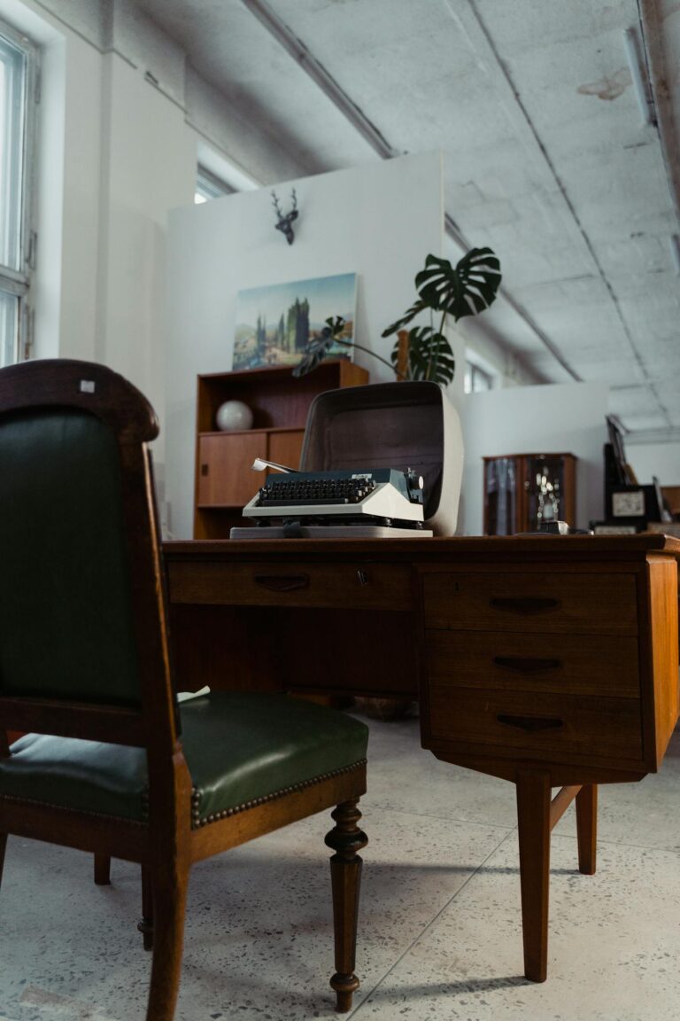 Cozy interior of a vintage-style office with retro furniture and an antique typewriter.